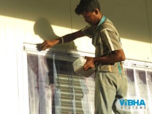 Fixing PVC strip curtains for temperature control in Bangalore warehouses.